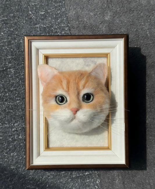Framed orange kitten portrait with large eyes and light whiskers