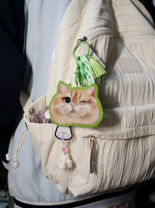 Cute cat face keychain with green tassel charm and white cord strap