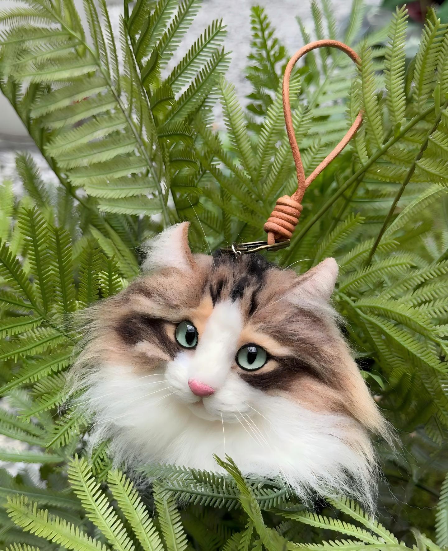 Tricolor cat face keychain with green eyes and brown cord loop