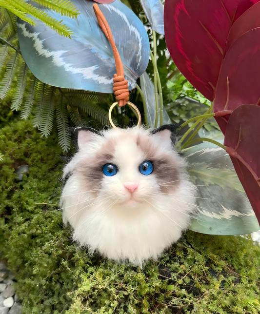 Fluffy cream cat pom keychain with blue eyes and light pink nose