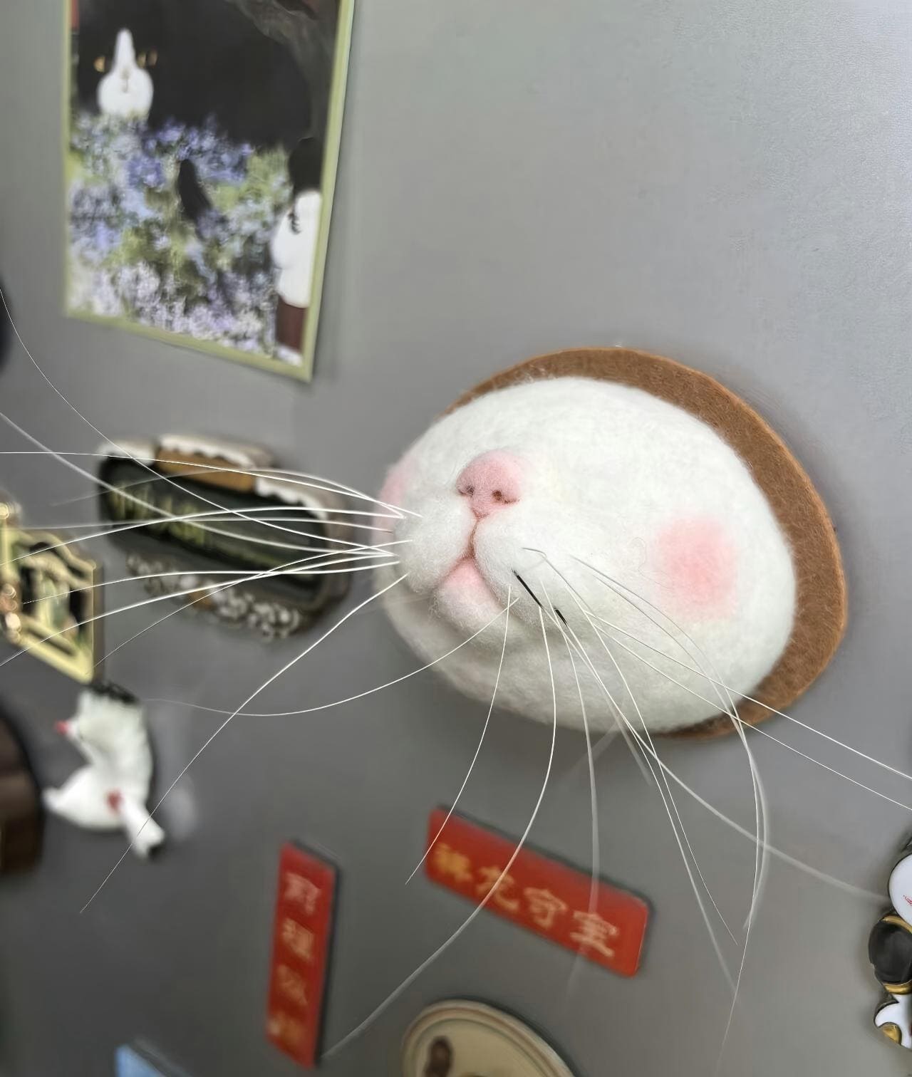 Felt cat face fridge magnet with brown border and pink nose