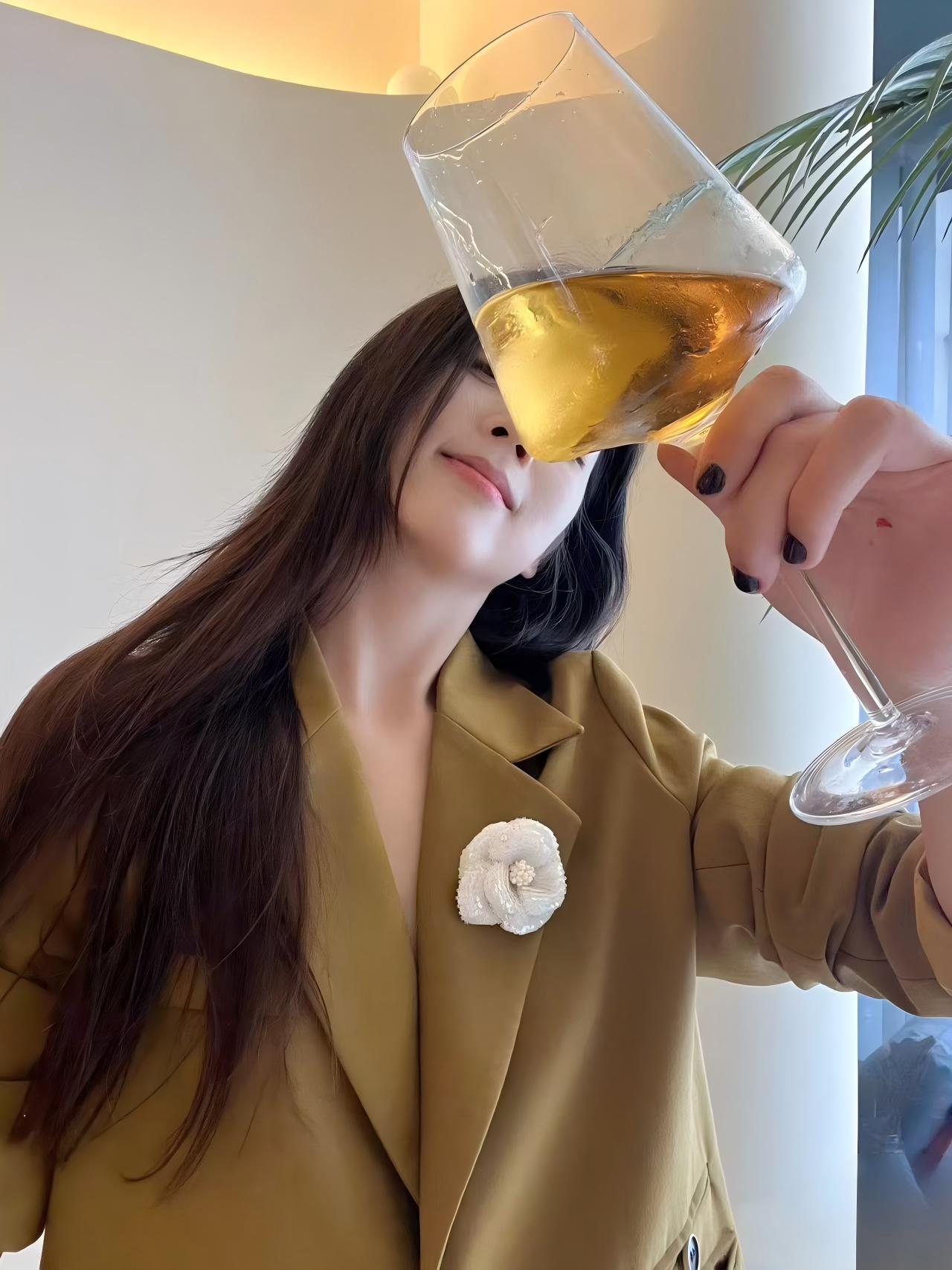 White camellia brooch on a tan blazer lapel with gold beaded petals