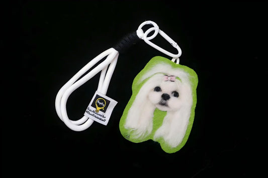 White pet face keychain with green plush body and white cord ring