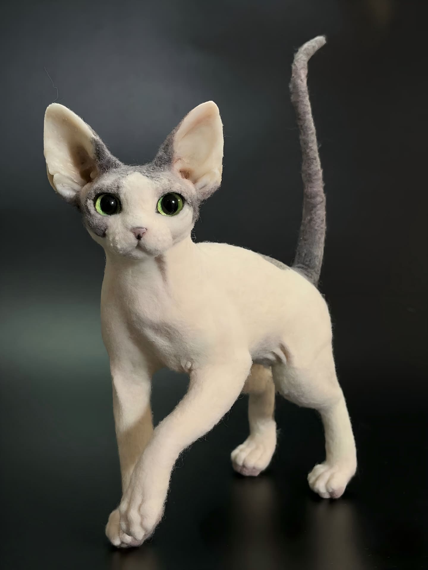 Full body cat figurine, white fur with light grey patches and green eyes, standing